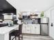 Open-concept kitchen featuring a breakfast bar, modern appliances, and hardwood floors at 2222 12Th Nw St, Winter Haven, FL 33881