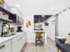 Well lit kitchen features modern appliances, sleek gray cabinets, and dark wood shelving at 2222 12Th Nw St, Winter Haven, FL 33881