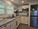 Bright kitchen with stainless steel appliances, granite counters, and modern finishes at 2222 12Th Nw St, Winter Haven, FL 33881