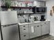 Charming kitchen featuring stainless steel appliances, stylish backsplash, and open shelving at 2222 12Th Nw St, Winter Haven, FL 33881