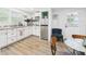 Well-lit kitchen with white cabinets, stainless steel appliances, granite countertops, and a door to the outside at 2222 12Th Nw St, Winter Haven, FL 33881