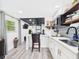 Cozy kitchen featuring bar-style seating and stylish tile backsplash at 2222 12Th Nw St, Winter Haven, FL 33881