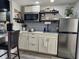 Modern kitchen with stainless steel appliances and open shelving at 2222 12Th Nw St, Winter Haven, FL 33881