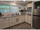 Bright kitchen with white cabinets, granite countertops, stainless steel appliances, and natural light at 2222 12Th Nw St, Winter Haven, FL 33881