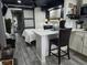 View of open living space showcases kitchenette, dining area, and bedroom with sliding barn door at 2222 12Th Nw St, Winter Haven, FL 33881