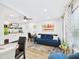 Open living space with a blue sofa, dining table, and kitchenette at 2222 12Th Nw St, Winter Haven, FL 33881