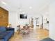 Inviting living room and dining area with wood accent wall and hardwood floors plus a view of the bathroom at 2222 12Th Nw St, Winter Haven, FL 33881