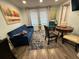 Inviting living room with a blue sofa, area rug, dining table with chairs, and natural light from the windows at 2222 12Th Nw St, Winter Haven, FL 33881