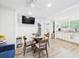 Open-concept living space with dining table, TV, and views of kitchen and bathroom at 2222 12Th Nw St, Winter Haven, FL 33881