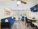 Cozy living room featuring a plush blue sofa, area rug, and stylish decor at 2222 12Th Nw St, Winter Haven, FL 33881