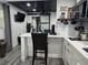 Open-concept living room features breakfast bar, modern lighting, and a sliding barn door at 2222 12Th Nw St, Winter Haven, FL 33881