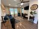 Cozy living room features a plush blue sofa, mounted TV, decorative rug, and a quaint dining area at 2222 12Th Nw St, Winter Haven, FL 33881