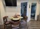 Cozy living room area with a round table set for four and a view into the bathroom at 2222 12Th Nw St, Winter Haven, FL 33881
