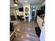 Open-concept living space with stylish decor, modern flooring, and seamless transition to the kitchen and bathroom at 2222 12Th Nw St, Winter Haven, FL 33881