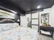 Bedroom offers a door to the side yard and a uniquely framed wall mirror at 2222 12Th Nw St, Winter Haven, FL 33881