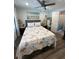 Comfortable bedroom with nautical bedding, a ceiling fan, ample natural light and attached bathroom at 2222 12Th Nw St, Winter Haven, FL 33881