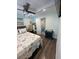 Bright bedroom with stylish nautical bedding, a ceiling fan, and easy access to the en-suite bathroom at 2222 12Th Nw St, Winter Haven, FL 33881
