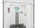 Stylish shower area with black and white patterned tiling and fixtures at 2222 12Th Nw St, Winter Haven, FL 33881