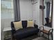 Cozy sitting area with comfortable loveseat, accent pillows, and a convenient side table at 2222 12Th Nw St, Winter Haven, FL 33881