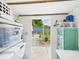 Organized storage space with shelves, plastic bins, and an open view of the backyard at 2222 12Th Nw St, Winter Haven, FL 33881