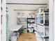 Well-organized storage room with shelving, clear plastic bins, and a folding table at 2222 12Th Nw St, Winter Haven, FL 33881