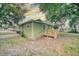Cozy home with a wooden deck and lush greenery, perfect for relaxing outdoors and enjoying the scenery at 230 Denton Ave, Auburndale, FL 33823
