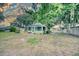 Charming cottage-style home featuring a cozy screened porch and verdant landscaping at 230 Denton Ave, Auburndale, FL 33823