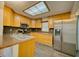 Functional kitchen with stainless steel appliances, light wood cabinets, and a skylight for ample lighting at 230 Denton Ave, Auburndale, FL 33823