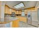 Well-lit kitchen featuring stainless steel appliances, wood cabinets, and modern countertops at 230 Denton Ave, Auburndale, FL 33823