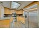 Well-lit kitchen featuring stainless steel appliances, ample cabinet space, and a skylight at 230 Denton Ave, Auburndale, FL 33823