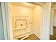Laundry room including space for washer/dryer hookups and storage at 230 Denton Ave, Auburndale, FL 33823