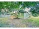 Charming home with a small wood deck nestled in a lush green lawn with mature trees at 230 Denton Ave, Auburndale, FL 33823