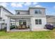 Backyard view of the patio, covered grill and lawn of a modern home at 2356 Palm Park Loop, Clermont, FL 34714