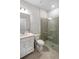 Bathroom featuring a clear glass shower, sink with mirror, and a toilet at 2356 Palm Park Loop, Clermont, FL 34714