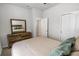Bedroom features a wooden dresser, and an open door at 2356 Palm Park Loop, Clermont, FL 34714