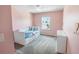 Bedroom features soft pink walls, a ceiling fan, and carpeted floors at 2356 Palm Park Loop, Clermont, FL 34714
