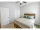 Bedroom features a closet, carpeted floors, and a ceiling fan at 2356 Palm Park Loop, Clermont, FL 34714