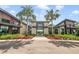 Community center entrance with well-manicured landscaping, palm trees, and a paved walkway at 2356 Palm Park Loop, Clermont, FL 34714