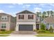 Charming two-story home with gray siding, brick driveway, red shutters, and well-maintained landscaping at 2356 Palm Park Loop, Clermont, FL 34714