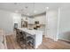Bright kitchen featuring stainless steel appliances, a quartz countertop island, and white cabinets at 2356 Palm Park Loop, Clermont, FL 34714