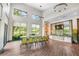 Bright and spacious community meeting room with large windows, a long table and comfortable chairs at 2356 Palm Park Loop, Clermont, FL 34714
