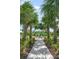 Community playground nestled among tropical palm trees provides a fun and safe space for children to play at 2356 Palm Park Loop, Clermont, FL 34714