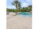 Community pool features a zero entry point, splash fountains and lounge seating, perfect for Gathering fun and relaxation at 2356 Palm Park Loop, Clermont, FL 34714