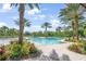 Resort-style pool with lush tropical landscaping and lounge seating, perfect for relaxation and community enjoyment at 2356 Palm Park Loop, Clermont, FL 34714