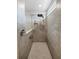 Modern walk-in shower features gray tile, a shower caddy, and a rain shower head at 2356 Palm Park Loop, Clermont, FL 34714