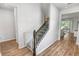 Well-lit stairway featuring a safety gate and wood-style flooring at 2356 Palm Park Loop, Clermont, FL 34714