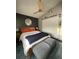 This cozy bedroom features stylish decor and a modern ceiling fan at 2516 Woodgate Blvd # 205, Orlando, FL 32822