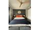 This cozy bedroom features stylish decor and a modern ceiling fan at 2516 Woodgate Blvd # 205, Orlando, FL 32822