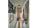 Hallway with decorative art and access to storage cabinets at 2516 Woodgate Blvd # 205, Orlando, FL 32822