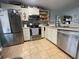 Well-lit kitchen featuring stainless steel appliances and tile flooring at 2516 Woodgate Blvd # 205, Orlando, FL 32822